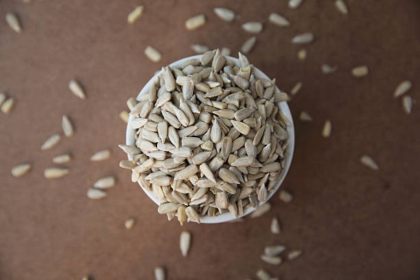 istock Sunflower seeds on wood background 517336746