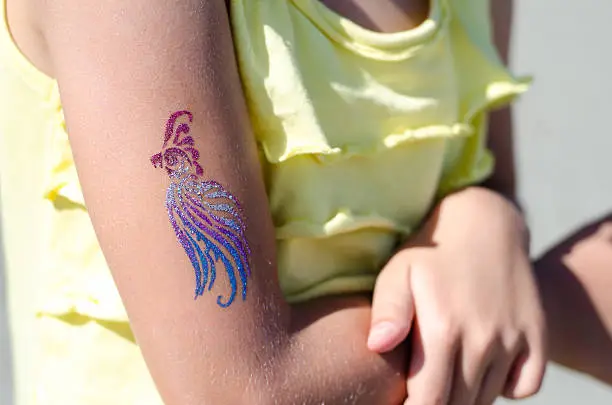 children cool colorful tattoo on the hand