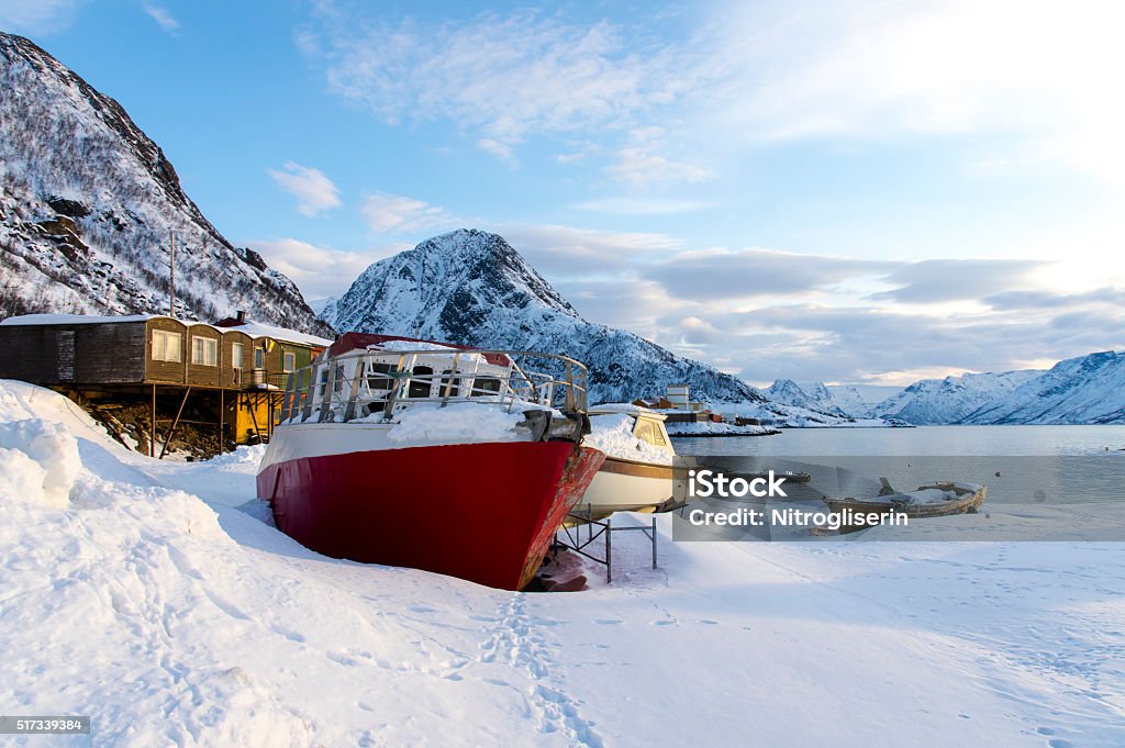 Winter Scenery in Norway Beached old rusty boat in Oksfjord, Norway along with winter scenery Alta - Norway Stock Photo