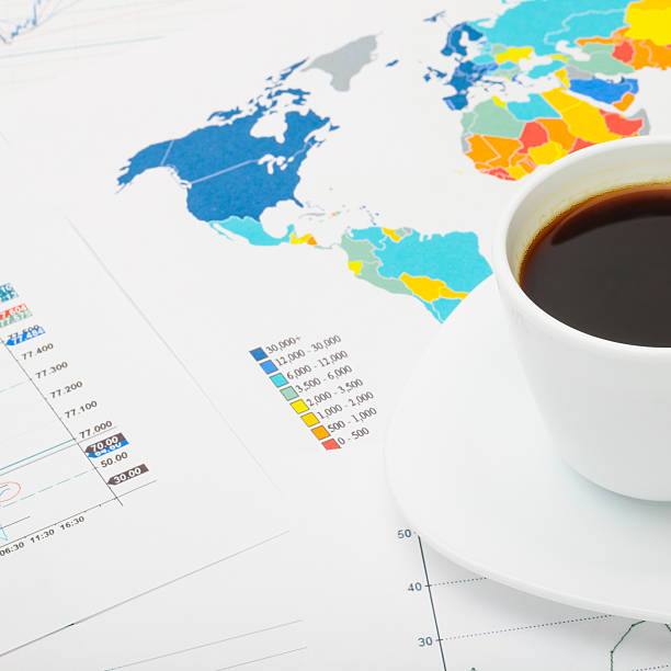 istock Coffee cup over financial documents - 1 to 1 ratio 517341399