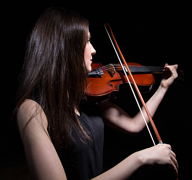 istock Brunette woman playing on violin from back 517341786
