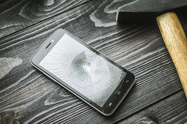 istock Smartphone with broken display on the wooden rustic background 517342754