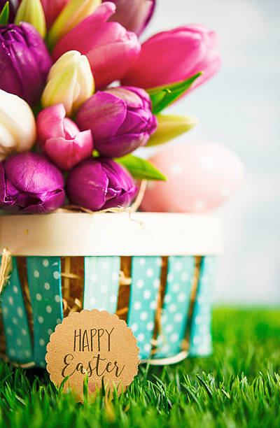 istock Tulip bouquet with Easter eggs and Easter basket in grass 517342816