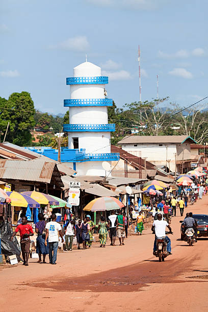 Gbarnga, Liberia - November 21, 2013: Main street and mosque in Gbarnga, Liberia. People are busy with daily activities: trading, shopping and transportation.