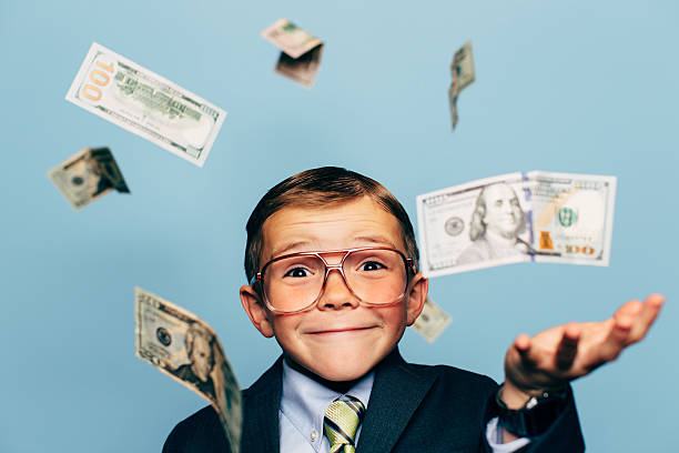 istock Young Boy Accountant Wearing Glasses with Falling Money 517343132