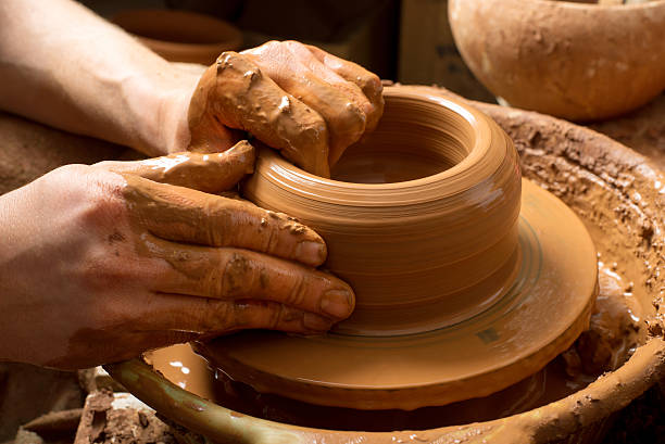 istock hands of a potter, creating an earthen jar 517343187