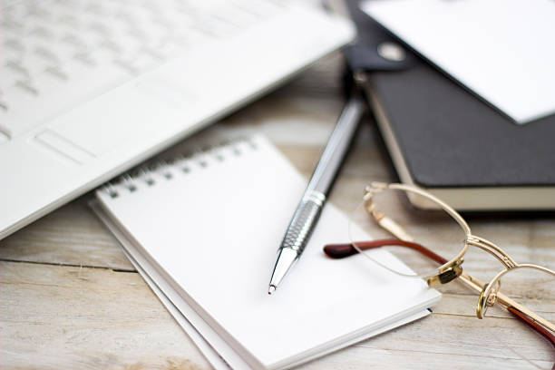 istock Office workplace with laptop and agenda on wood table 517343998