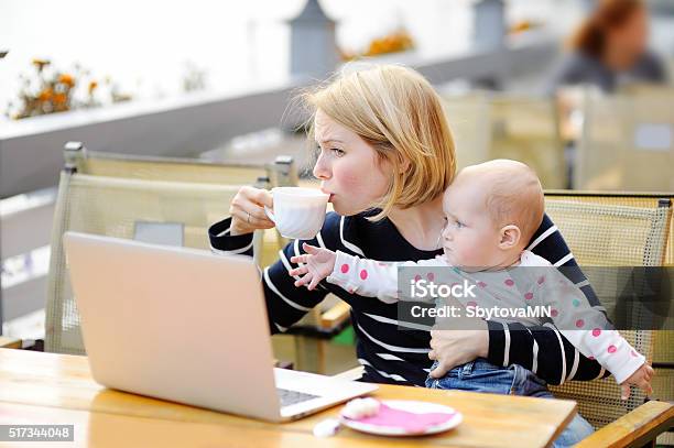 Tired Young Mother Holding 6month Daughter And Drinking Coffee Stock Photo - Download Image Now