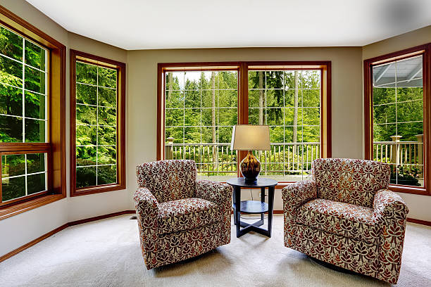 istock Comfort sitting area with large french windows 517344539