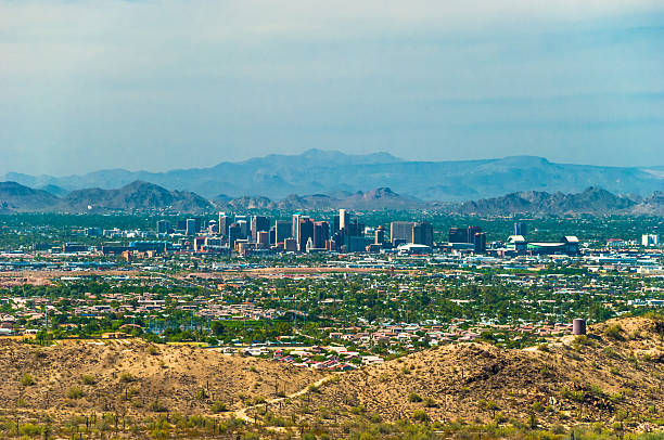 istock Downtown Phoenix skyline with mountains, aerial overview, and desert with cactus 517344866