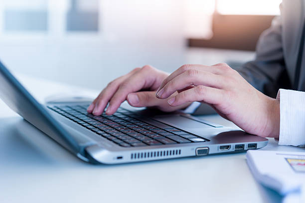 istock Close up of business man hands typing on laptop computer 517345177