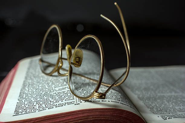 old open book with antique glasses on it