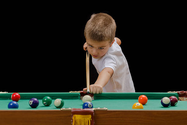 Beautiful boy playing billiard (pool) stock photo