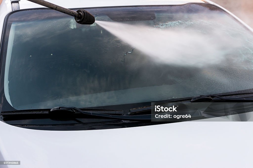 Front window wash. Front window on car is beeing pressure vashed by a water jet. Bath Sponge Stock Photo