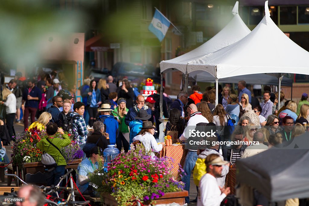 Crowd of people at an outdoor festival A crowd of people having a good time on a sunny day at an outdoor festival. Traditional Festival Stock Photo