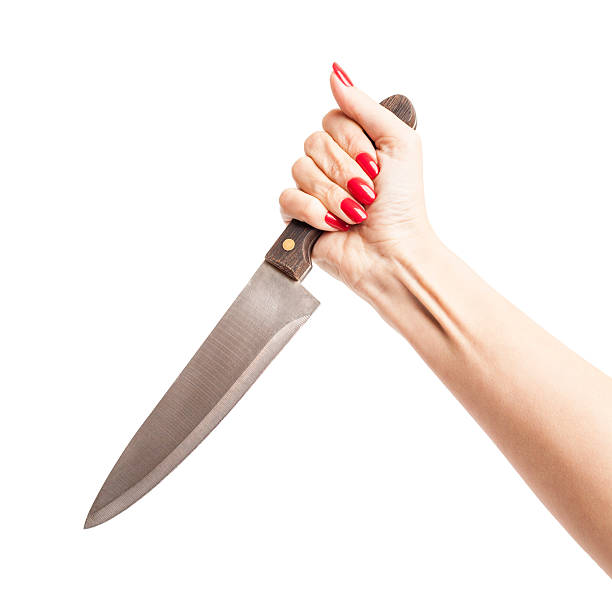 istock Female Hand Holding a Knife in a Threatening Way 517346117