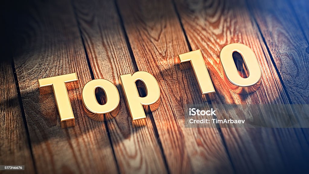 Word Top 10 on wood planks The word "Top 10" is lined with gold letters on wooden planks. 3D illustration image Number 10 Stock Photo