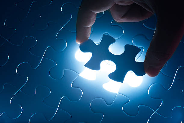 istock Hand holding the last piece of jigsaw puzzle 517347281