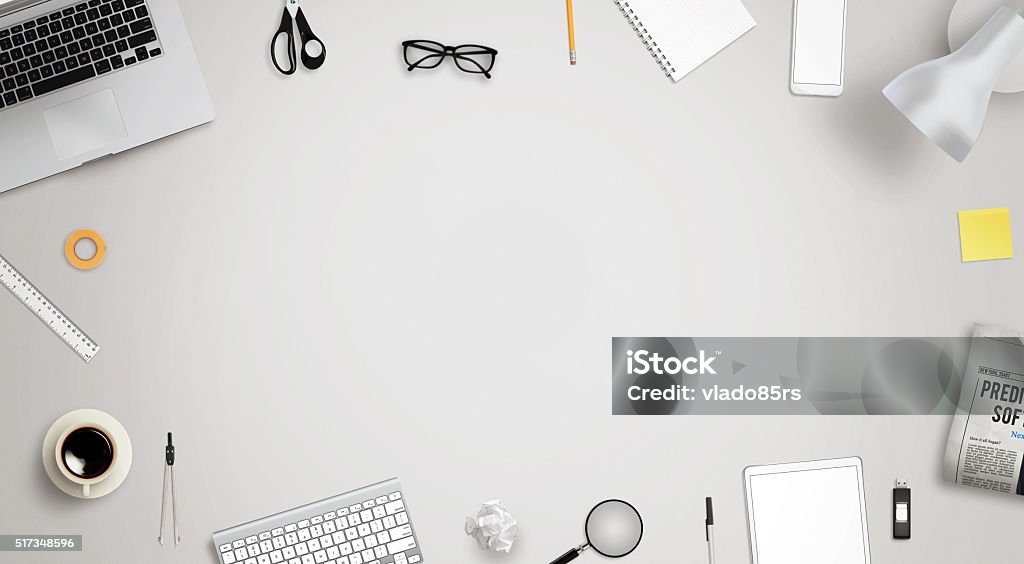 Work desk with free space for text surrounded with Work desk with free space for text surrounded with a lot of desk accessories. There is a laptop, tablet, phone, camera, headset, mouse, glasses, camera, pens, paper... Free of Charge Stock Photo