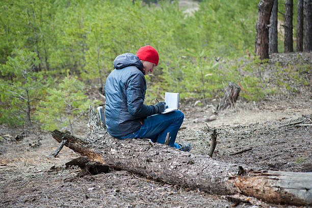 istock man traveling in a pine forest 517348762
