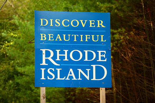 Welcome to Rhode Island sign at the Connecticut state line west of Providence, Rhode Island along state route 101.