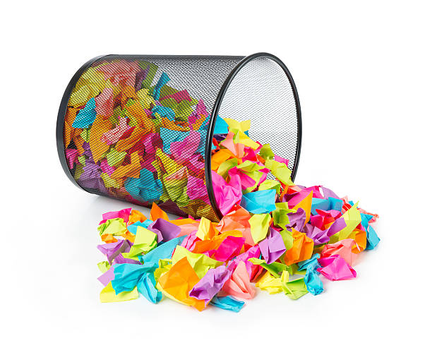 Full trash with colored paper on white background