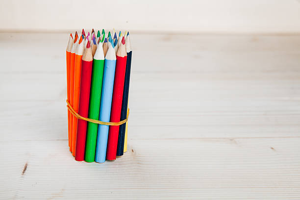 istock Colored pencils in wooden background 517360735