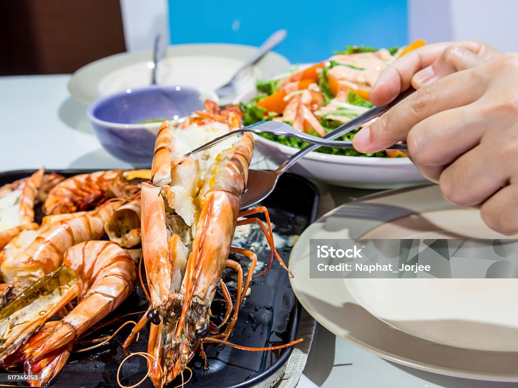 Dinner at restaurant, roasted black tiger shrimp menu Woman dinner at restaurant, roasted black tiger shrimp menu Appetizer Stock Photo