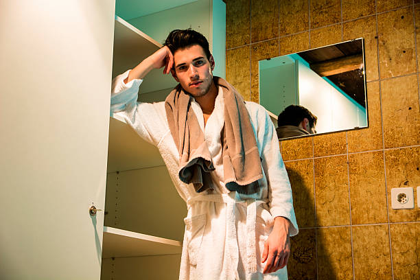 istock Young man wearing white bathrobe in spa 517368630