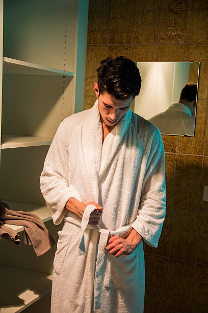 istock Young man wearing white bathrobe in spa 517368684