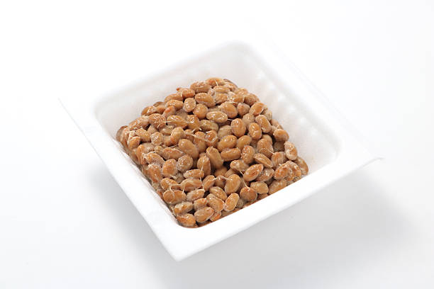 Natto, fermented soybeans Natto, fermented soybeans on white background. natto stock pictures, royalty-free photos & images