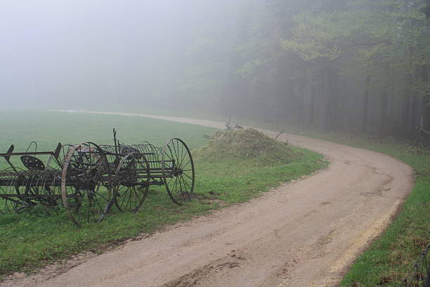 istock old Farm equipment in the mist 517371542