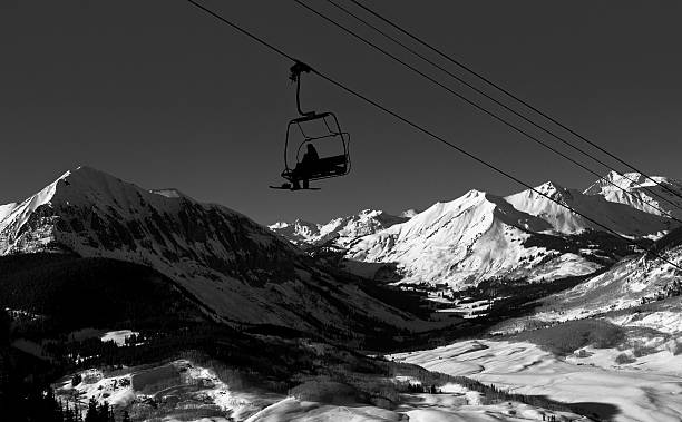 istock silhouetted snowboarder on a ski lift 517372334