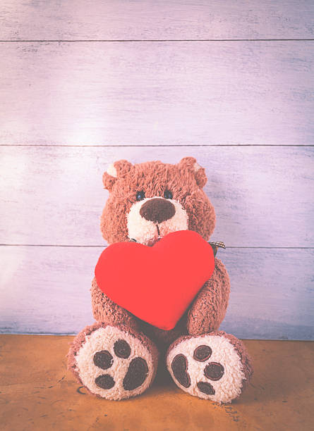 istock Teddy bear holding red heart 517372424
