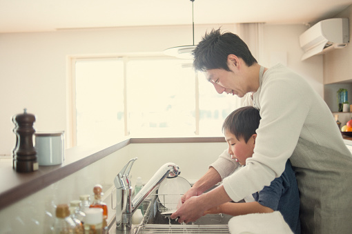Father and son are the housework together