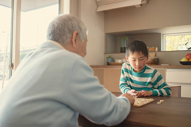 istock Grandfather and grandson playing with Japanese chess 517373642