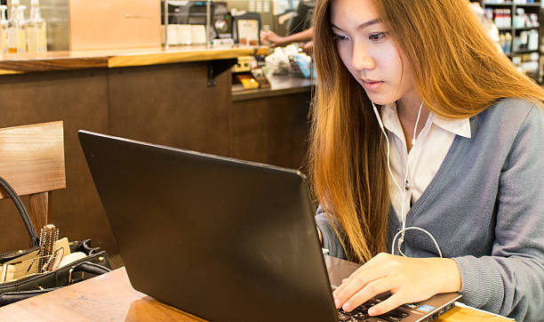 istock Asian woman student working on a laptop 517373656