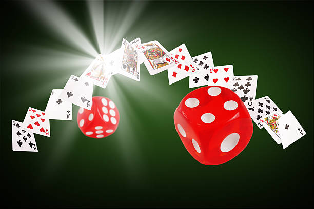 istock Playing cards and dice flying at the poker table 517373712