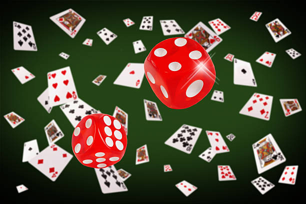 istock Playing cards and dice flying at the poker table 517373878