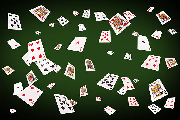 istock Playing cards flying at the poker table 517373934