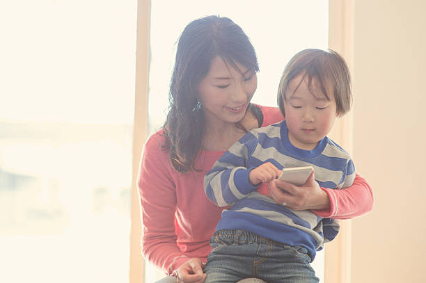 istock Mother and son using a digital tablet at home 517374040