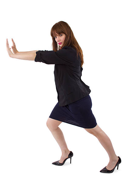 istock Young Businesswoman Pushing Something 517374899