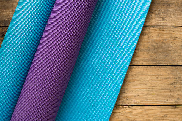 istock yoga mats on wood table 517375260