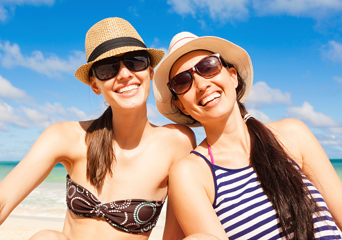 Beautiful young women enjoying summer day at the beach
