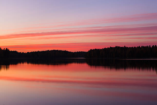 istock Serene view of calm lake and tree silhouettes 517376688