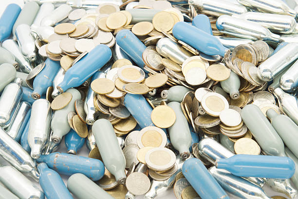 istock Stack of silver and blue gas container with gold coins 517376748