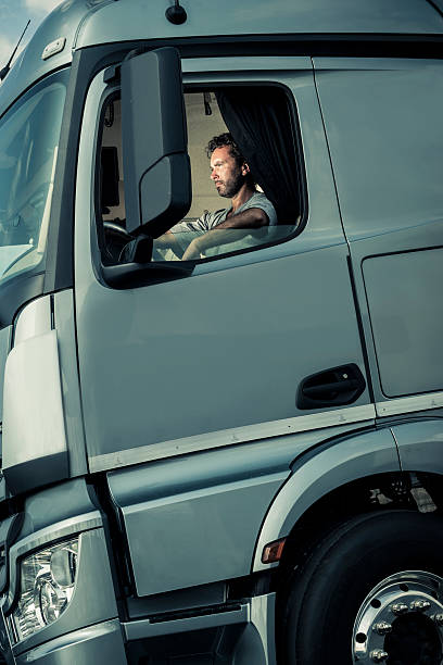 istock Truck Driver Sitting In Cab 517377515