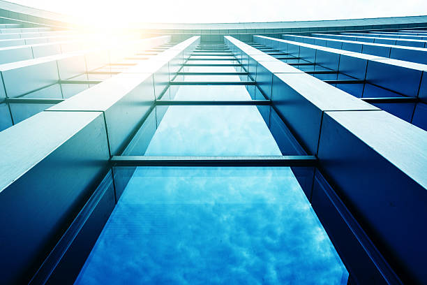istock view of a contemporary glass skyscraper reflecting the blue sky 517379034