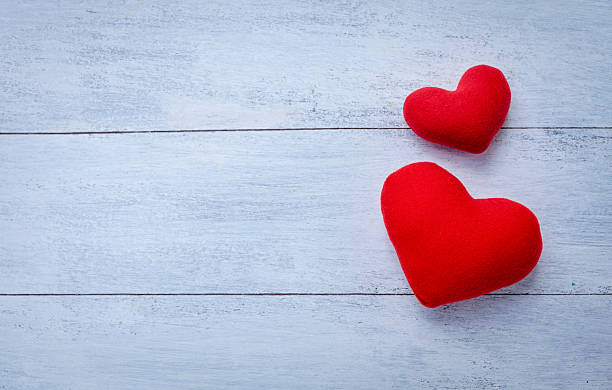 istock Two red hearts on wood background 517379056