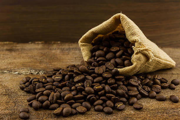 istock Brown roasted coffee beans in canvas sack. 517379103